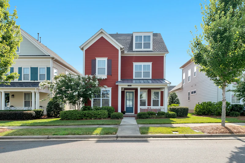 Two-story home with red lap siding and white trim
