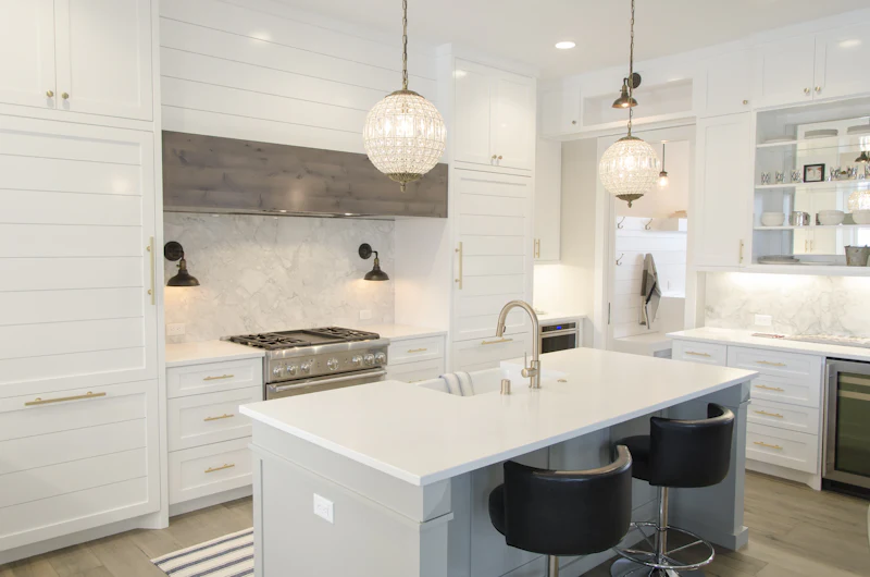 Bright white kitchen with an island and pendant lights